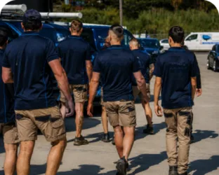 Plumbers walking to their service vans on a Frenchs Forest job